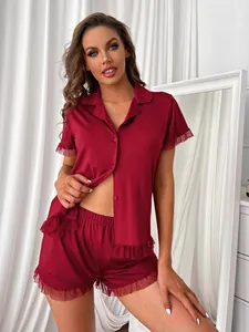 Detailed view of women's red two-piece pajama set with elegant lace ruffle trim accents