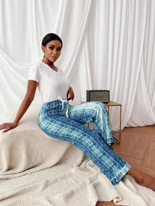 Casual women's pajamas set with white V-neck top and blue snake print wide-leg pants