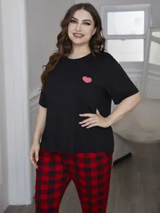 Plus size pajama set featuring a heart print short sleeve top and red plaid pants