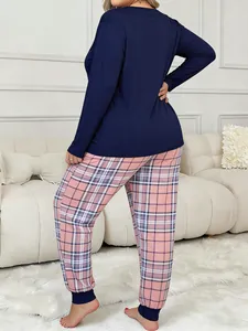 Back view of plus size women's navy long sleeve top and pink plaid pajama pants set