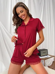 Model wearing red summer pajamas set with delicate lace trim shown in a home setting