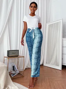Stylish women's pajama set featuring snake print pants and a white short-sleeve top.