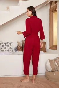 Back view of elegant burgundy long-sleeve jumpsuit loungewear with black piping detail