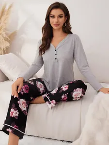 Cozy grey long-sleeved top and black floral print pajama pants set for women.