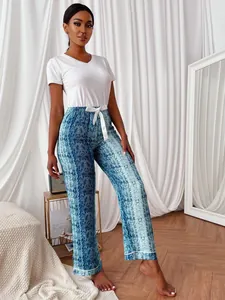 Women's two-piece pajama set with white V-neck top and blue snakeskin print pants