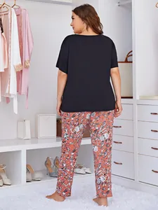 Back view of women's plus size pajama set featuring black top and floral printed pants.