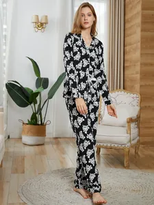Elegant women's two-piece black and white floral pajama set with long sleeves and pants