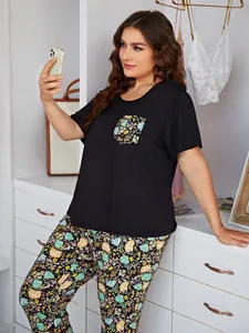 Plus size floral pajama set with black short sleeve top and floral long pants for women
