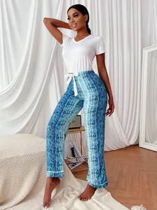 Detailed view of women's blue snake-print pajama pants and a classic white V-neck t-shirt.