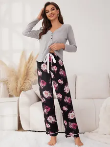 Elegant women's two-piece floral pajama set featuring a gray long-sleeved top and printed pants