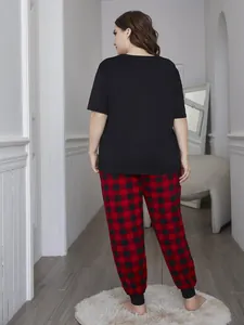 Back view of plus size women's pajama set with black t-shirt and red plaid pants