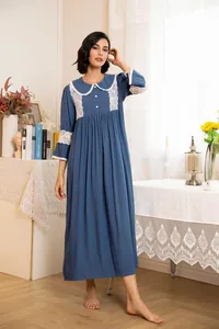 Detailed view of a vintage palace-style blue nightdress with white lace collar and cuffs
