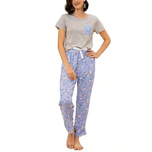 Two-piece women's pajama set with grey short sleeve top and floral print long pants.