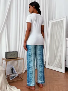 Rear view of women's pajama set with white short sleeve top and blue snake print trousers.