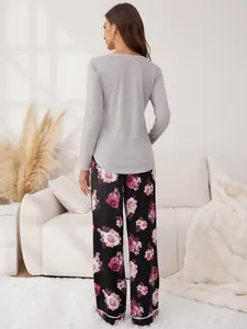 Back view of women's cozy floral pajama set featuring grey top and printed pants