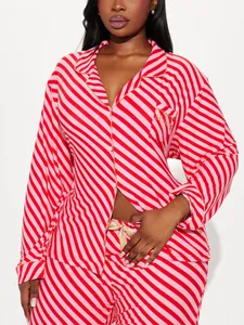 Detailed view of red and pink striped pajama set featuring 'Blessed' gold embroidery