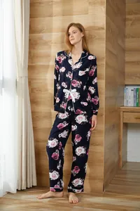 Two-piece dark blue floral long-sleeve pajama set for women in a cozy home setting
