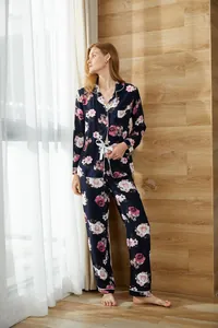 Full-body detail view of women's floral long-sleeve pajama set in cozy home setting