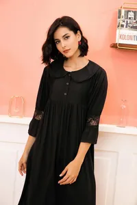 Detail of a vintage palace-style black nightgown with delicate lace sleeves and collar.