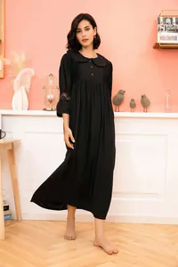 Full body shot of a vintage black nightdress with lace details and a Peter Pan collar.
