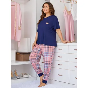 Comfortable plus size women's navy heart top and pink plaid pajama set in closet