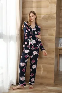 Full view of women's navy blue floral pajama set with long sleeves and bow detail