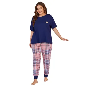 Plus size women's pajama set featuring navy heart short sleeve top and pink plaid pants