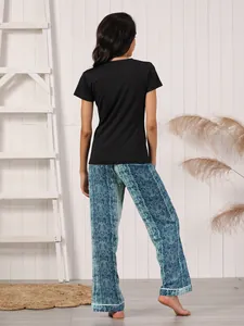Back view of women's loungewear set with black top and blue snakeskin print pants