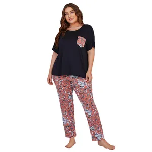Plus size women's pajama set with short sleeve black top and floral patterned pants