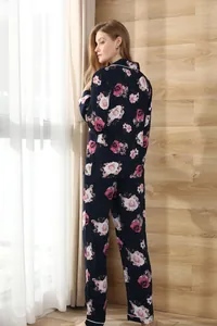 Rear view of women's long-sleeve pajama set with pink rose print on navy background