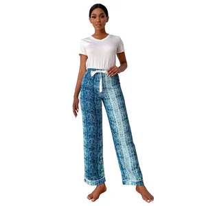 Full-body view of women's pajamas set with snakeskin print pants and white short sleeve top