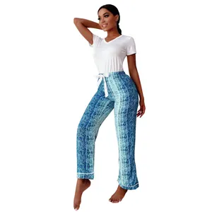 Detailed view of a women's two-piece pajama set featuring blue snakeskin print long pants