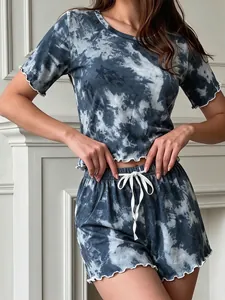Detail of blue tie-dye pajama set featuring lettuce trim and white drawstring waist