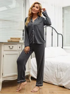 Full view of grey long-sleeved pajama set with white piping and a chest pocket