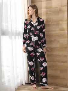 Full body view of women's floral print long-sleeve pajama set in a cozy home setting
