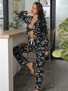 Elegant women's black floral pajama set featuring a long-sleeved cardigan in a cozy home setting