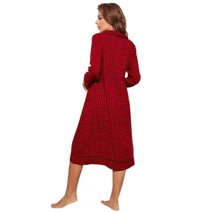 Back view of a woman wearing a long red and black plaid nightgown with long sleeves.