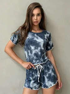 Detail of women's blue tie-dye pajama set with ruffle trim and drawstring shorts