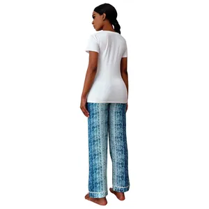 Back view of women's white short sleeve t-shirt and blue patterned pajama pants set