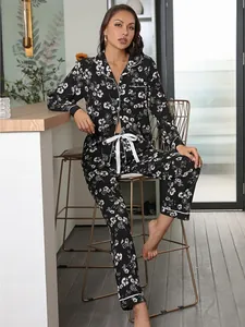 Elegant black floral long-sleeved pajama set worn by model in a modern home environment