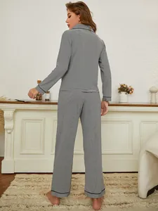 Detailed back view of women's classic black and white striped pajama set in a home setting