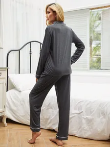 Back view of a dark grey long-sleeved pajama set featuring elegant white piping detail.