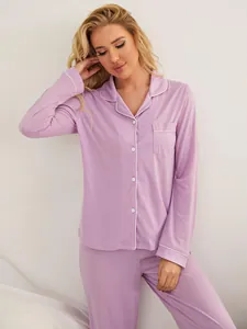 Close-up of woman wearing soft purple two-piece long-sleeve button-down pajama set