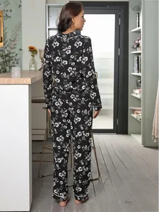 Elegant back view of women's black floral pajama set featuring long sleeves and long pants.