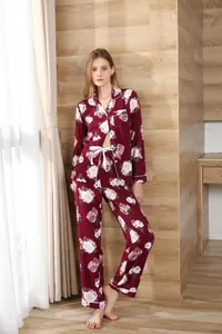 Elegant full-body view of a women's burgundy floral long sleeve pajama set in home setting