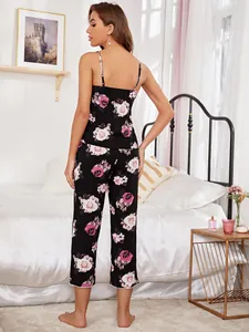 Back view of floral print camisole and pants pajama set in a cozy bedroom setting.