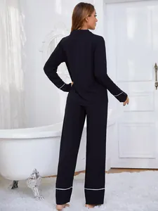 Elegante vista trasera de pijama negro para mujer con ribetes blancos estilizados