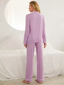Back view of a comfortable lilac long-sleeve pajama set with white piping details