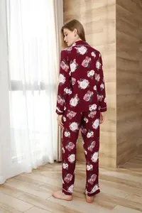 Detailed rear view of a women's floral burgundy pajama set in a cozy home setting.
