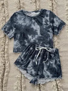 Close-up detail of grey tie-dye pajama set featuring ruffled edges and comfy elastic waist.